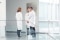 Three doctors meeting in the hallway of a hospital