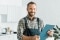The image shows an installer smiling and holding a clipboard.