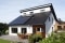 The picture shows photovoltaics on the roof of a detached house.